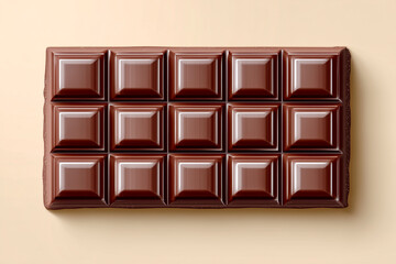 Fototapeta premium A perfectly crafted dark chocolate bar with glossy, square sections lays on a smooth beige background, showcasing its luxurious appeal and rich texture.