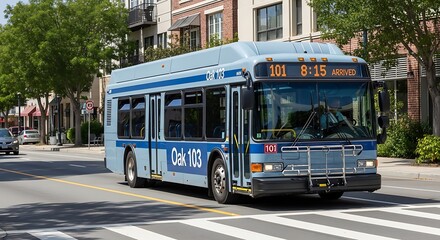 Fototapeta premium A light blue oak bus with the number one hundred and one on the front driving on a city street