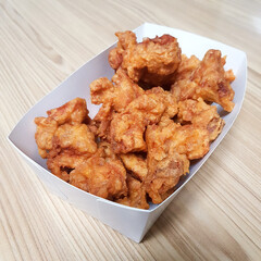 A series of images showing pieces of crispy fried chicken. The photos highlight the golden-brown...