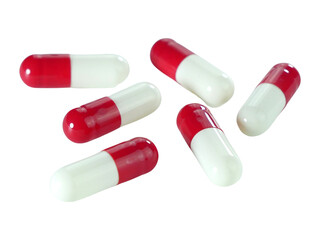Bulk red and white capsule pills isolated on white background.
