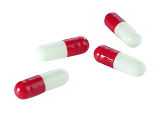 Bulk red and white capsule pills isolated on white background.