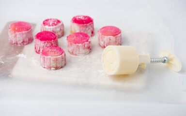 Homemade Chinese snow skin mooncakes. Snowy Moon cakes on a White Background. Mid-Autumn Festival, traditional Asian desserts, and seasonal celebrations in Asian countries