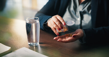 Water, pills and hands of woman in home for medical treatment, prescription and tablets for recovery. House, health and person with medication container for vitamins, supplements and drugs on table