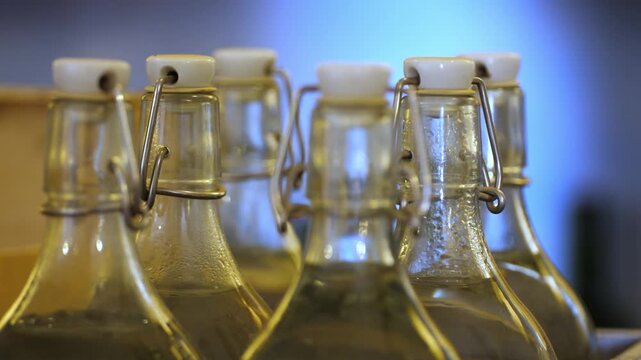 footage of vintage swing top closure bottles in wooden crate, showing traditional glass containers with swing top mechanism