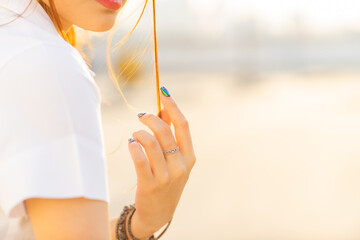 As the warm afternoon sunlight illuminates, a close-up of the female student's beautifully...