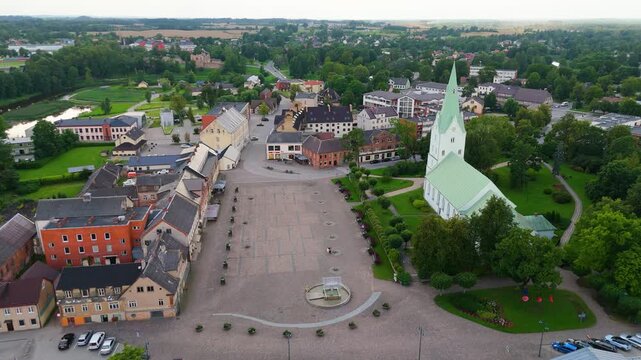 Aerial Panorama of Dobele Town Center and Evangelical Lutheran Church at Summer Scenic Drone View in Golden Hour Light Over Dobeles Historic Center on a Warm Summer Evening Peaceful Latvian Town