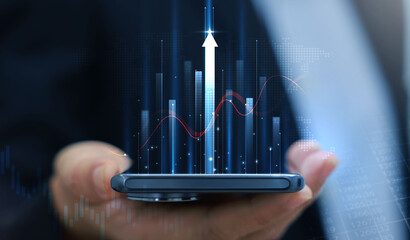 Businessman holding smartphone with glowing stock market chart and upward arrow. Financial growth, investment success, fintech, and trading technology concept. business stock market.