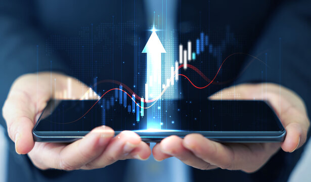 Businessman holding smartphone with glowing stock market chart and upward arrow. Financial growth, investment success, fintech, and trading technology concept. business stock market.