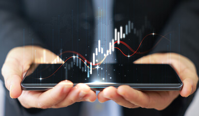 Businessman holding smartphone with glowing stock market chart and upward arrow. Financial growth, investment success, fintech, and trading technology concept. business stock market.