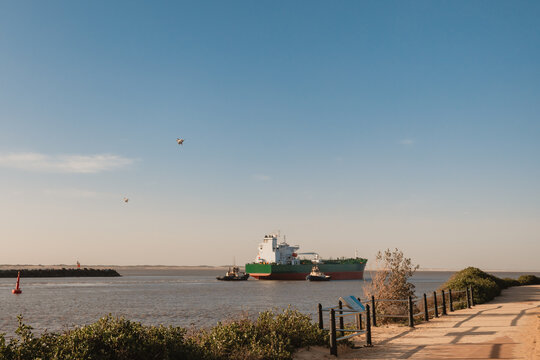 RAAF jets flying over cargo ship leaving Newcastle Port on the Hunter River