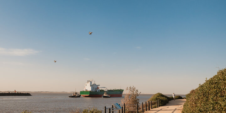 RAAF jets flying over cargo ship as it leaves Newcastle Port on the Hunter River
