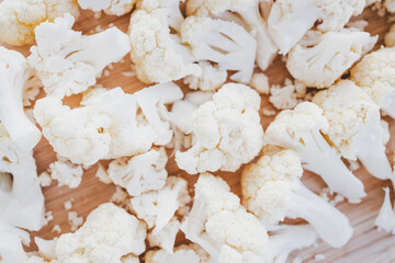 chopped cauliflower on wooden cutting board for healthy cooking themes