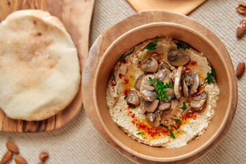 Delicious Hummus Topped with Sautéed Mushrooms and Garnished with Paprika and Fresh Herbs, Served...
