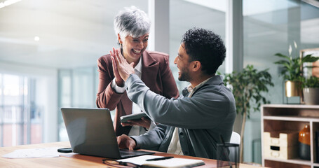 Business success, laptop and people with high five for trading bonus, teamwork and investment. Excited man, mature woman and tech with celebration in office for stock market growth and achievement