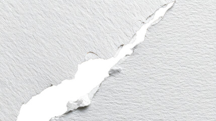 Torn paper with a jagged edge revealing black underneath on a white isolated background.