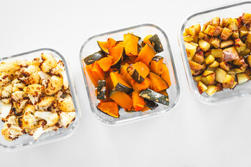 meal prep glass containers with roasted cauliflower pumpkin yellow capsicum and potatoes
