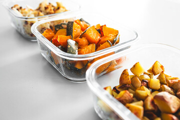 meal prep glass containers with roasted cauliflower pumpkin yellow capsicum and potatoes