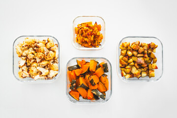meal prep glass containers with roasted cauliflower pumpkin yellow capsicum and potatoes