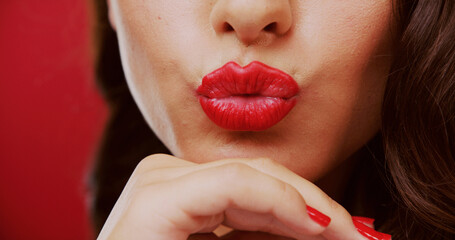 Pout, lipstick and woman in studio for beauty, makeup and cosmetology with mouth on red background....