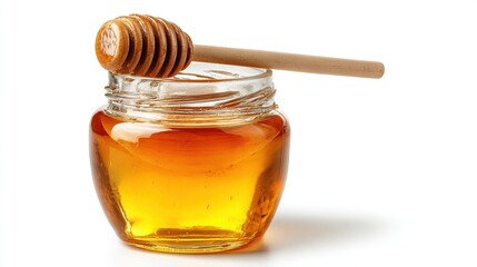A glass jar filled with golden liquid and topped with a wooden drizzler.  Bright light, isolated on white