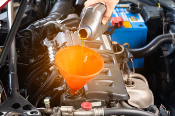 Refueling and pouring oil quality into the engine motor car Transmission and Maintenance Gear...