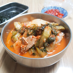 A close-up of a hearty and savory kimchi stew with pork (dwaeji-gogi kimchi-jjigae).