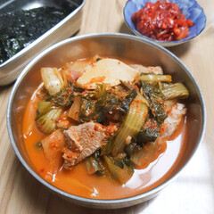 A close-up of a hearty and savory kimchi stew with pork (dwaeji-gogi kimchi-jjigae).