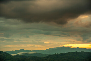 Scenic view dramatic beautiful sunset sky. Natural Sunset Sunrise on meadow silhouette shadow dark land. Vibrant dramatic sky on sunset, dawn, sunrise in Countryside. Landscape Colorful Sky At Sunset