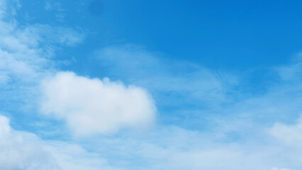 Soft white clouds with a beautiful blue sky in the morning light. Soft white clouds float in the clear blue sky. Clear blue sky, bright spring, soft sky gradient.