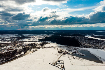 Aerial view of cumulus clouds floating over snowy landscape