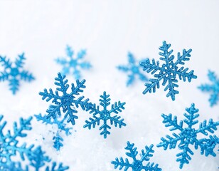 Blue glitter snowflakes scattered on a snowy white background