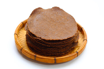 Fermented soybean discs, known as “Thua Nao,” a traditional Thai seasoning used to enhance flavor in Northern cuisine.