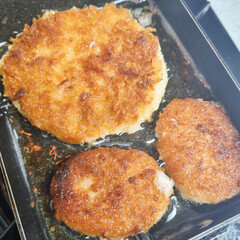 A close-up of a plate of crispy breaded and deep-fried pork cutlets (donkaseu), a simple and savory meal.