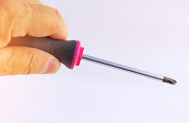 Hand holding electrical tools to assemble the electrical control panel. 