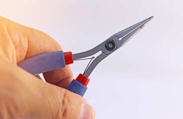 Hand holding electrical tools to assemble the electrical control panel. 