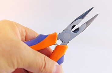 Hand holding electrical tools to assemble the electrical control panel. 