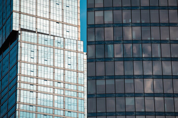 Obraz premium mirrored windows of the facade of an office building with blue panels