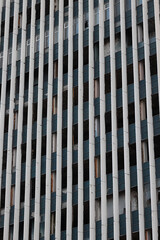 Texture And Pattern Of A Derelict Building Facade With Rows Of Broken Windows And Peeling Paint....