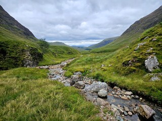 View of the July landscape in Scotland, lush greenery, mountains, heather, cloudy weather