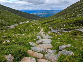 View of the July landscape in Scotland, lush greenery, mountains, heather, cloudy weather