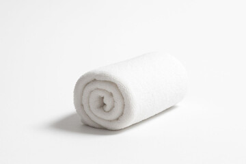 Rolled white towel on a white background