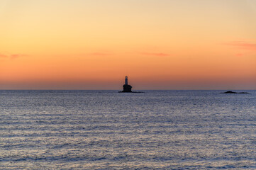 Fototapeta premium Sunrise at Tourlitis Lighthouse off the Coast of Andros, Greece