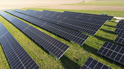 Solar panels collecting sustainable energy at sunset. generating clean and renewable energy in a...