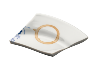Fragmented white ceramic plate shard with sharp edges, faint blue floral pattern, and dried light brown coffee stain, isolated on transparent background, soft studio lighting, minimalist study of