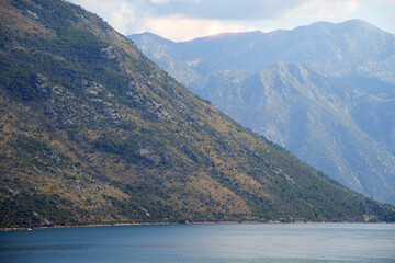 Misty mountain landscape with lush vegetation and bay