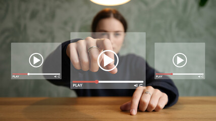 Woman pointing at a central play button on a digital video interface media entertainment