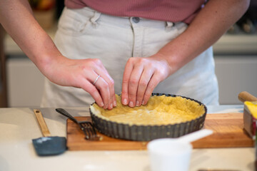 preparing the pastry shell for a frangipane tart