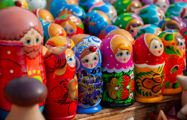 Brightly colored nested dolls displayed at a market showcasing traditional craftsmanship in vibrant...