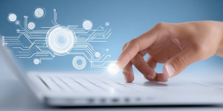 Digitalization concept featuring a hand touching a laptop keyboard with a futuristic circuit graphic overlay