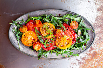 Simple Italian Salad with Tomatoes and Arugula on rusty background, Italian Food
